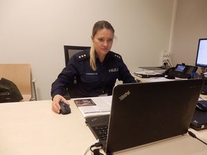 policjantka siedząca przed laptopem
