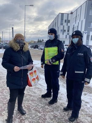 policjanci rozdający ulotki seniorom