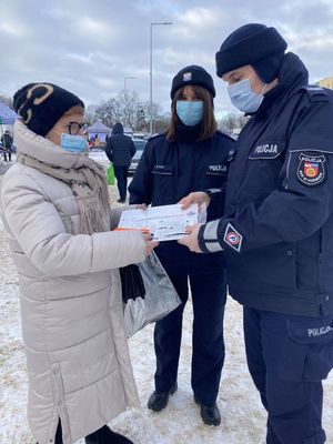 policjanci rozdający ulotki seniorom