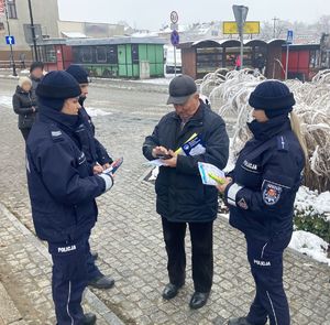 policjanci rozdający broszury