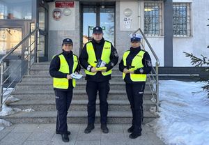 policjanci roznoszący odblaski i broszury